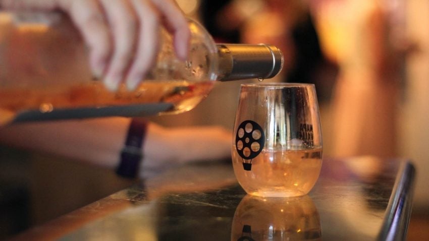 Napa Valley wine being poured into a glass carrying the Napa Valley Film Festival mark